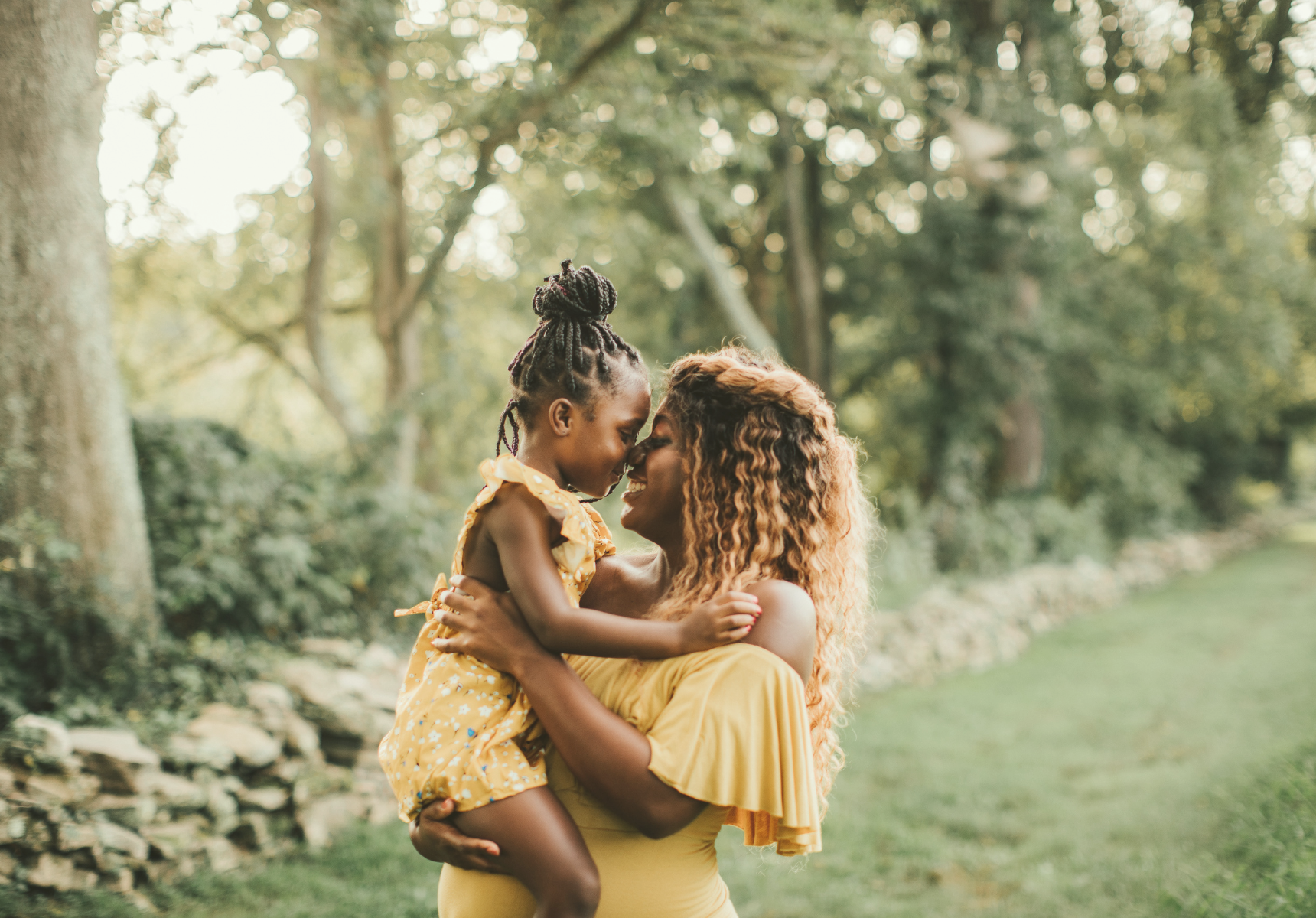 Mother and daughter sharing a tender moment outdoors
